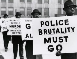 Black and white photograph of men protesting police brutality.